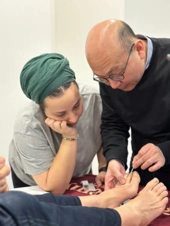 Dr Michael Chung demonstrating needling of a Tung point on the toe to a participant